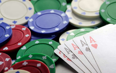 four aces with casino chips on green table clot