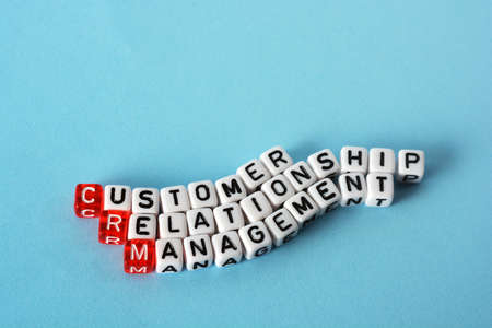 CRM Consumer Relationship Management on cubes , definition  acronym on blueの写真素材
