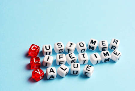 CLV Customer Lifetime Value written on dices on blue  backgroundの写真素材