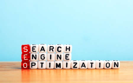 SEO Search Engine Optimization written on dices  on blue background