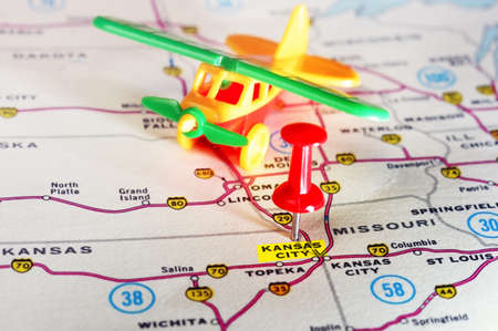Close up of Kansan City USA  map with red pin and airplane toy  - Travel conceptの写真素材