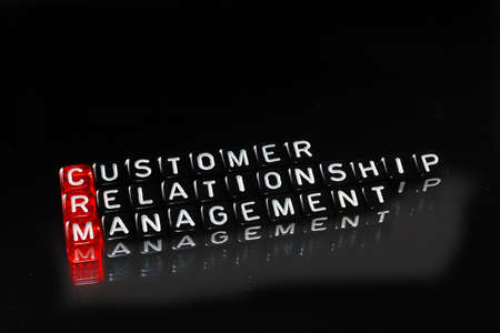 CRM Consumer Relationship Management on cubes , definition acronym on blackの写真素材