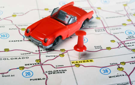 Close up of state Kansan USA map with red pin and cabrio car - Travel conceptの写真素材