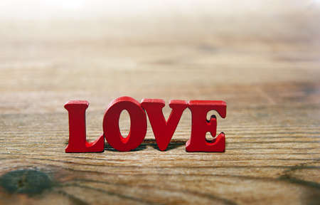 LOVE- word made from red   letters on wooden  backgroundの写真素材