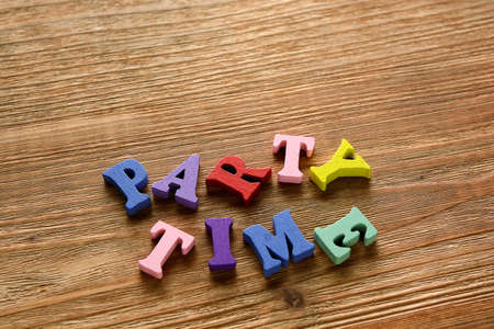 party time  - words  made from multicolored   letters on wooden  backgroundの写真素材