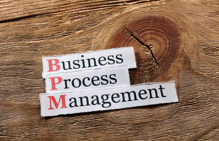 BPM business process management on  paper ,wooden backgroundの写真素材