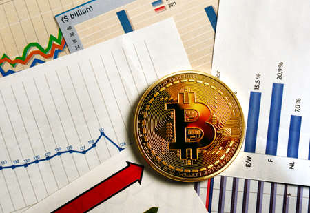 A golden bitcoin on graph and diagrams  background. Concept of trading  crypto currencyのeditorial素材