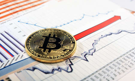 A golden bitcoin on graph and diagrams  background. concept of trading  crypto currencyのeditorial素材