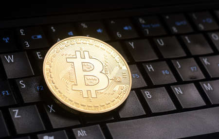 Golden bitcoin  coin  on laptop  keyboardのeditorial素材
