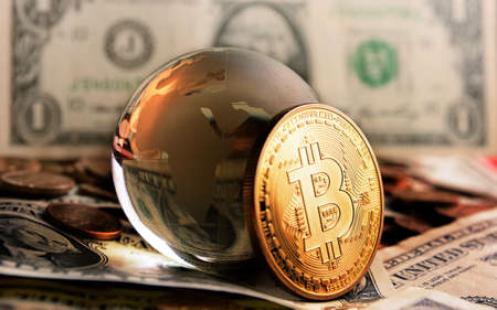 bitcoin coin and cristal globe over  one dollar banknoteの写真素材