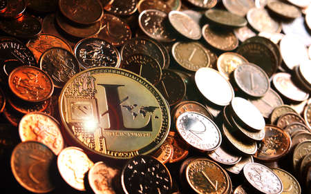 Golden  Litecoin crypto currency on heap of golden coins