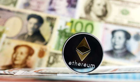 Ethereum coin against of different banknotes on background. Cryptocurrency Trading concept .の写真素材