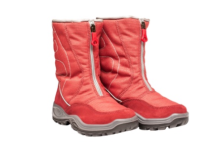 two children s red waterproof boots on a white backgroundの写真素材