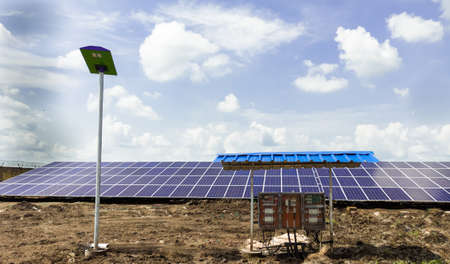 Row of installed Photovoltaic solar panels or modules, solar street light and string combiner box, string monitoring box with weather protective canopy.の写真素材