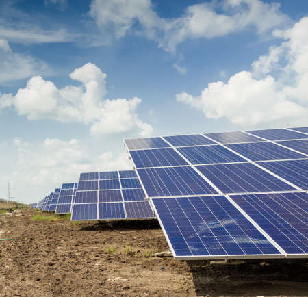 Side view of Installed row of Photovoltaic solar panels / modules at solar power station. Clear sky sunny day clear view.の写真素材