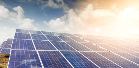 Close up view of installed Photovoltaic solar panels or modules and clear sky, sunny day with sun flair.の写真素材