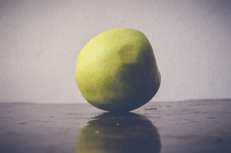 green apple on wooden tableの写真素材