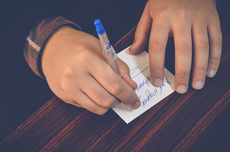 businessman writing on white paper in office, business conceptの写真素材