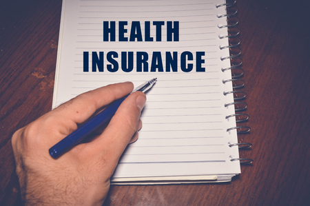 Health Insurance written on white paperのeditorial素材