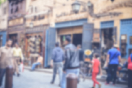 blurred background of people walking in the streetの写真素材