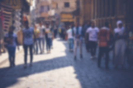 blurred background of people walking in the streetの写真素材