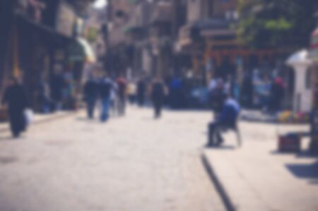 blurred background of people walking in the streetの写真素材