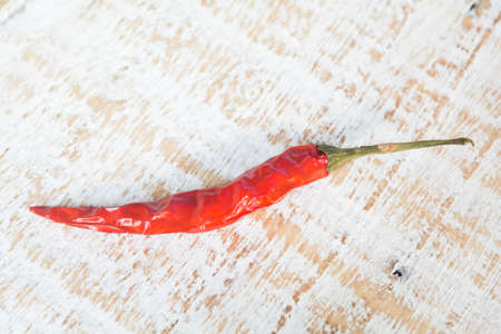 dried red chilli pepper on wood backgroundの写真素材
