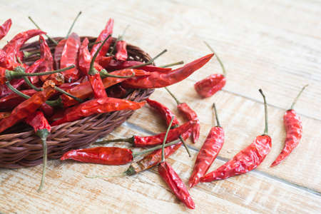 dried red chilli pepper on wood backgroundの写真素材