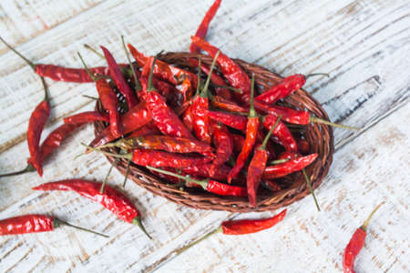 dried red chilli pepper on wood backgroundの写真素材