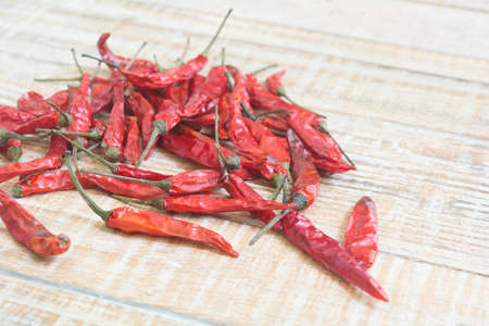 dried red chilli pepper on wood backgroundの写真素材