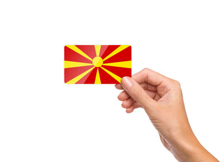 Beautiful hand holding Macedonia flag card on white backgroundの写真素材