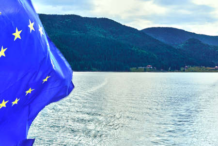 European Union flag waving and blue sky background.の写真素材