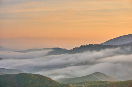 Beautiful Sunrise over Clouds and Mountainsの写真素材