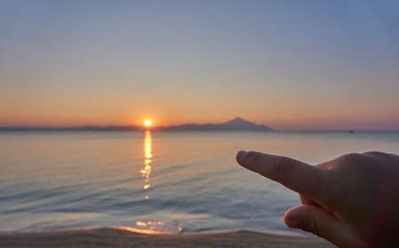 Wonderful sunrise view behind the mountains and next to the sea