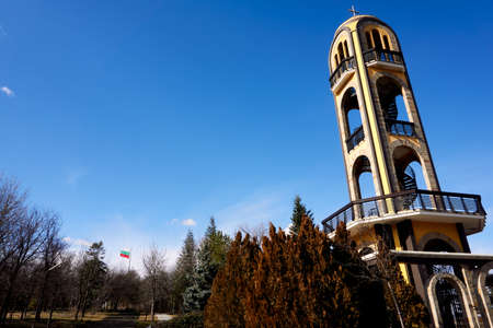 Haskovo, Bulgaria - January 30, 2020: The bell tower of Haskovo next to the Monument of Virgin Mary.The bell tower is build on a hill where you can see all the city from above.Photo was taken on a sunny winter day.のeditorial素材