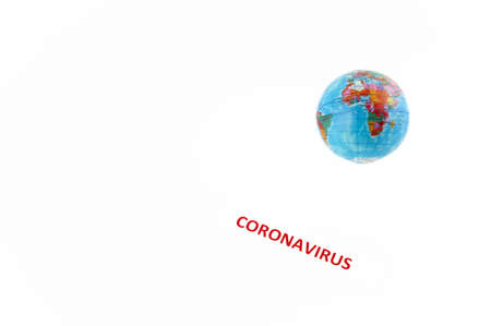Coronavirus label next to the world globe