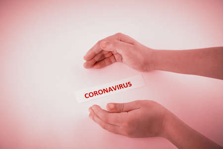 Hands of a child trying to keep coronavirus under controlの写真素材