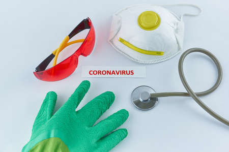 Coronavirus label next to protective wear and stethoscopeの写真素材
