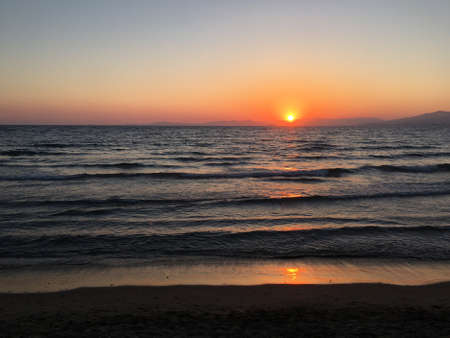 Wonderful sunrise view behind the mountains and next to the seaの写真素材