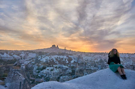 Goreme, Cappadocia / Turkey - October 24, 2020: Panoramic cityscape photo of Goreme Town in Nevsehir, Turkey. Tourists looking at the wonderfull sunset view.のeditorial素材