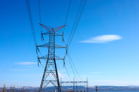 High voltage towers with hanging power linesの写真素材