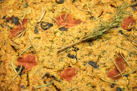 Homemade bread with rosemary, dried olives and tomatoes
