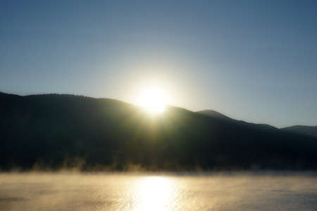 Sunrise over the mountain with reflection on the lakeの写真素材