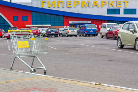 an empty cart with a view of the sign of the hypermarketのeditorial素材
