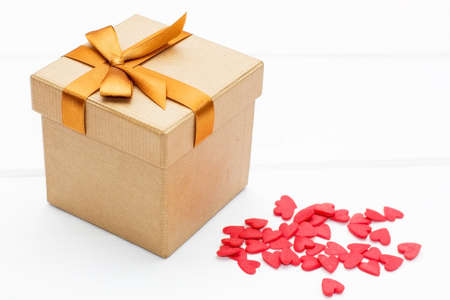 gift box with lots of little hearts on a white background. festive concept for Valentine's day,...