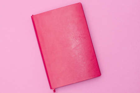 pink diary on a pink background. business concept for women. Flat lay, Top view.の写真素材