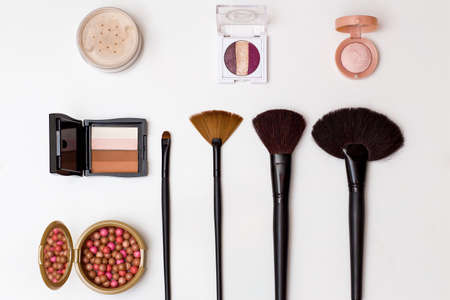 cosmetics makeup brushes eye shadow Foundation powder on white background top view. beauty flat lay conceptの写真素材