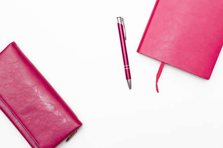pink diary, pen and wallet womens pink on a white background. business minimal concept for women. Flat lay, top viewの写真素材