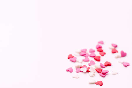 several small hearts in white pink and red on a white background. festive background for Valentine's day, birthday, holiday, weddingの写真素材