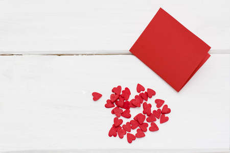 red card and a few little hearts around. romantic love background for Valentine's day, birthday, holiday, partyの写真素材